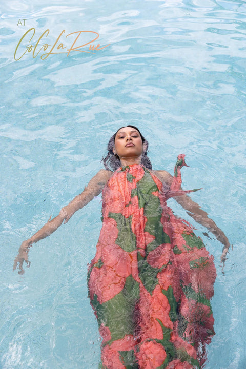 CLR Peach Flower Maxi an exclusive tropical floral print.  Cut away under the arm creating a trapeze silhouette with soft gathers falling to a voluminous and undulating maxi length skirt. A perfect dress for carry on your vacation trip this summer.