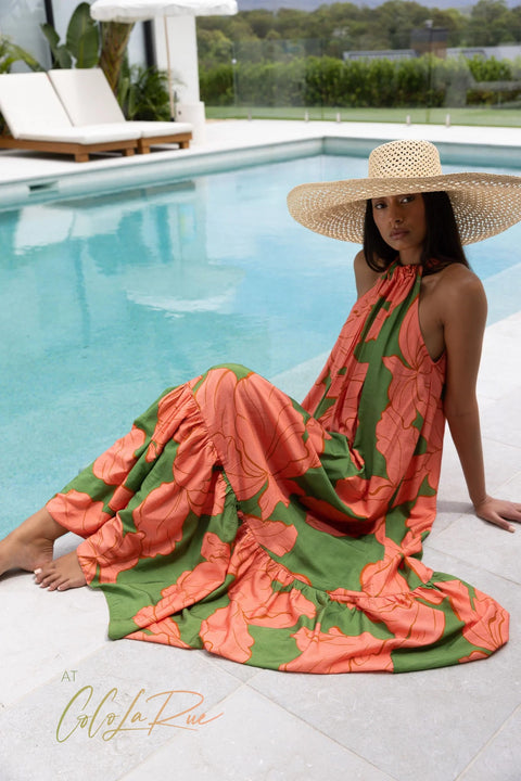 CLR Peach Flower Maxi an exclusive tropical floral print.  Cut away under the arm creating a trapeze silhouette with soft gathers falling to a voluminous and undulating maxi length skirt. A perfect dress for carry on your vacation trip this summer.